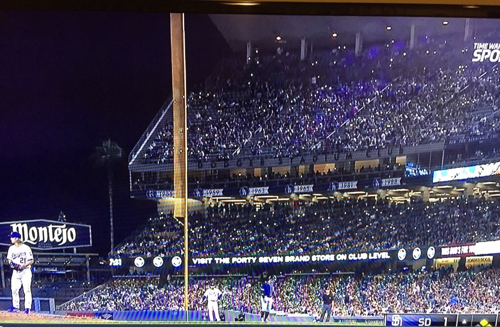 Fans at Dodger Stadium hold their lighted cell phones up for Zack Greinke. October 3, 2015.